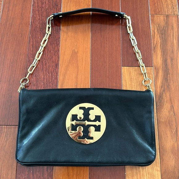 Tory Burch black leather clutch with detachable strap. Two zipper pockets.